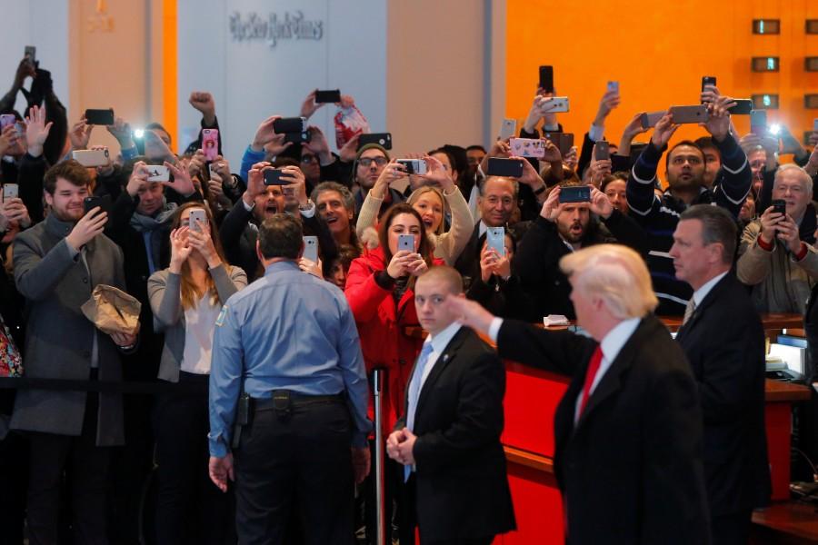 A gathered crowd reacts to President-elect Donald Trump in the lobby of the New York Times building. Donald Trump,President-elect Donald Trump,Donald Trump meets New York Journalists,Donald Trump meets New York Journalists and executives,New York Journalists,New York Journalists and executives