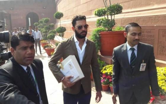 Photos of Indian Cricket player Yuvraj Singh arrives to parliament with his mother to invite PM Narendra Modi for his wedding.