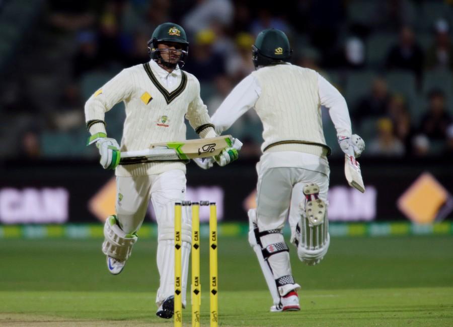Australian batsman Usman Khawaja (L ) and Matt Renshaw score runs during the first day of the Third Test cricket match in Adelaide. Australia v South Africa,Australia v South Africa pics,Australia v South Africa images,Australia v South Africa photos,Australia v South Africa stills,Australia v South Africa pictures,Australia v South Africa test match,Day-night Test at Adelaide Oval