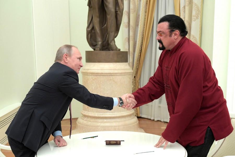 Russia's President Vladimir Putin shakes hands with American actor Steven Seagal during a meeting at the Kremlin in Moscow, Russia, November 25, 2016. Putin presented a Russian passport to Seagal on Friday and said he hoped it would serve as a symbol of how the fractious ties between Moscow and Washington are starting to improve. Vladimir Putin,President Vladimir Putin,Putin,Steven Seagal,actor Steven Seagal,US actor Steven Seagal,Russian passport to US actor Steven Seagal