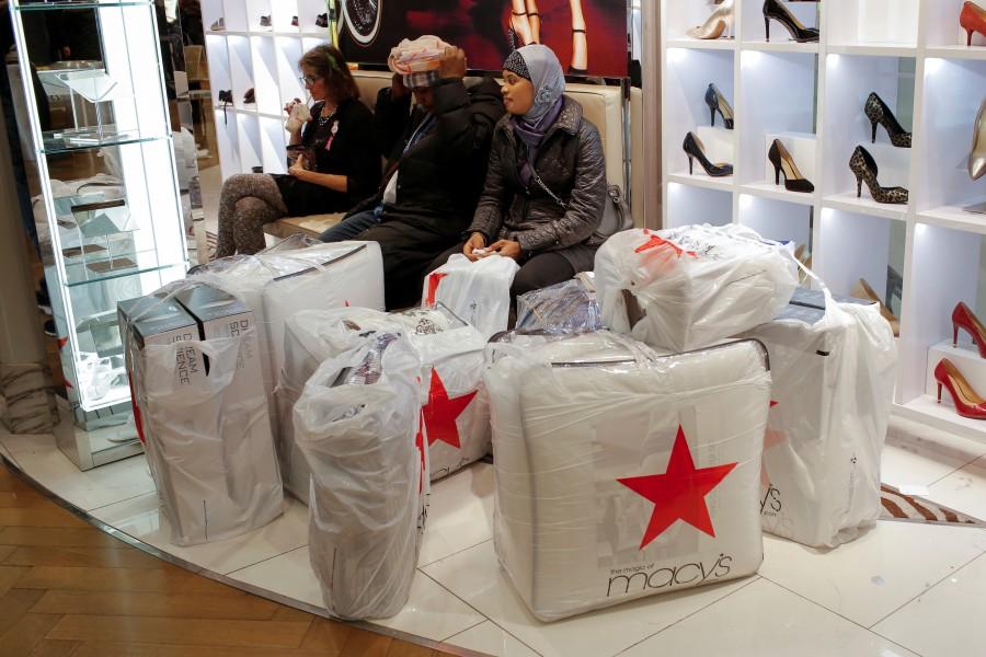 People wait with purchases at Macy's Herald Square in Manhattan, New York. Thanksgiving,Thanksgiving bargain hunt,Black Friday frenzy,Black Friday frenzy pics,Black Friday frenzy images,Black Friday frenzy photos,Black Friday frenzy stills,Black Friday frenzy pictures
