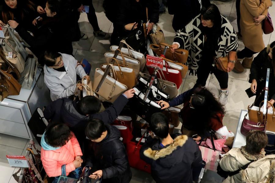 People look at a rack of handbags at Macy's Herald Square in Manhattan, New York. Thanksgiving,Thanksgiving bargain hunt,Black Friday frenzy,Black Friday frenzy pics,Black Friday frenzy images,Black Friday frenzy photos,Black Friday frenzy stills,Black Friday frenzy pictures