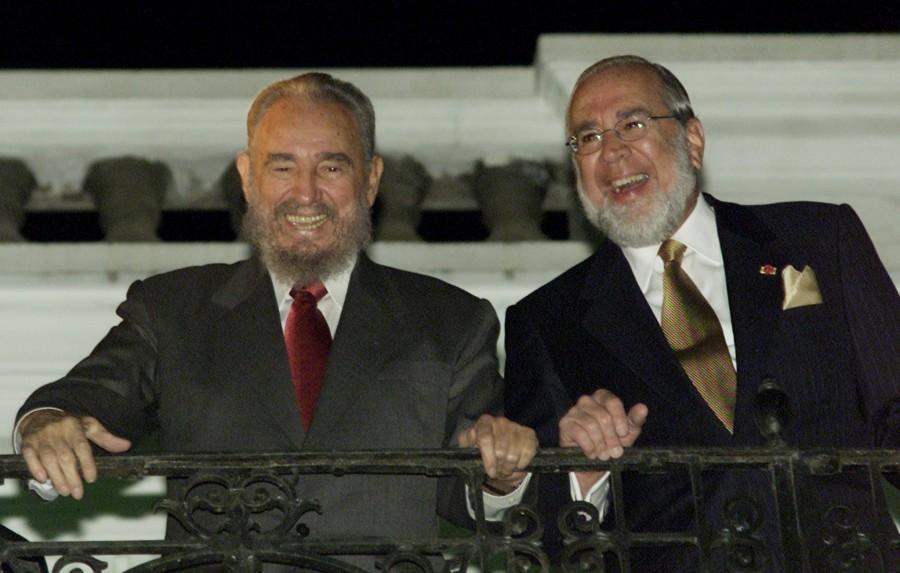 Cuban President Fidel Castro ((L) and Ecuadorean President Gustavo Noboa greet supporters on the balcony at the Carondelett Palace in Quito, November 28, 2002. Castro is in Ecuador to attend the inauguration ceremony for Ecuadorean artist's Oswaldo Guayasamin work "La Capilla del hombre" (the chapel of Man), in Quito November 29. Guayasamin, who was Castro's personal friend, had been working on his top work "The Chapel of Man" when he died, on March 10, 1999. Fidel Castro,Fidel Castro dead,Fidel Castro cuba,Fidel Castro dies,Fidel Castro passes away,Fidel Castro Iconic photos,Fidel Castro Iconic pics,Fidel Castro Iconic images,Fidel Castro rare pics,Fidel Castro rare images,Fidel Castro rare photos,Fidel Castr