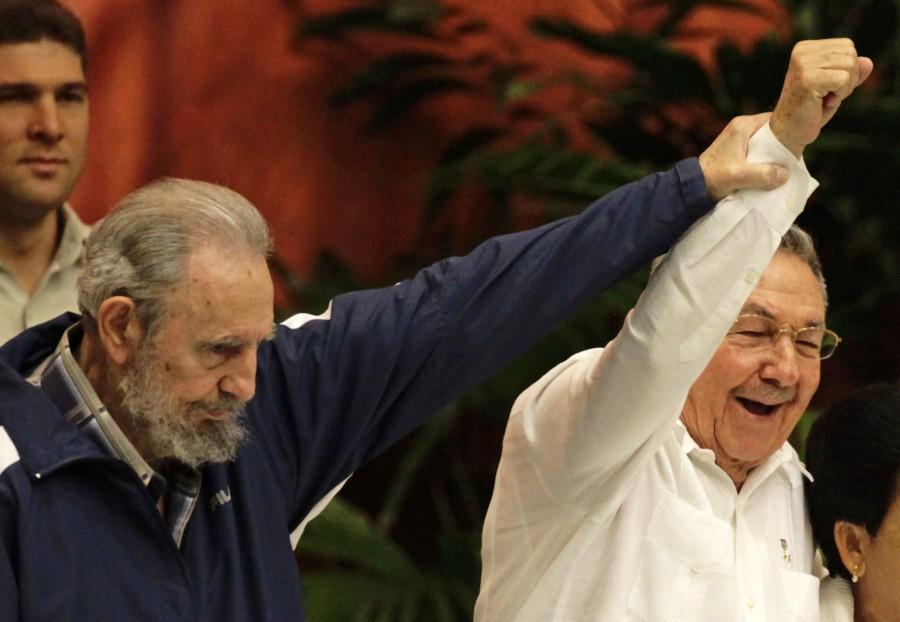 Former Cuban leader Fidel Castro (L) holds up the arm of his brother, Cuba's President Raul Castro, during the closing ceremony of the sixth Cuban Communist Party (PCC) congress in Havana in this April 19, 2011 file photo. Revolutionary icon Fidel Castro turns 86 on August 13, 2012, out of sight, but not out of mind as Cubans wonder about his future and theirs at a time of change in one of world's last communist countries.The bearded leader who was a constant presence and transfixed Cubans for decades with his fiery rhetoric, still holds a special place in the hearts and minds of the Caribbean island's 11 million residents, even as age and infirmity force him farther into the background. Picture taken April 19, 2011. Fidel Castro,Fidel Castro dead,Fidel Castro cuba,Fidel Castro dies,Fidel Castro passes away,Fidel Castro Iconic photos,Fidel Castro Iconic pics,Fidel Castro Iconic images,Fidel Castro rare pics,Fidel Castro rare images,Fidel Castro rare photos,Fidel Castr