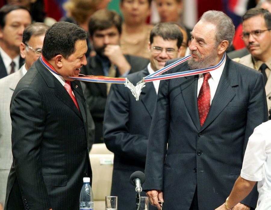 Venezuela's President Hugo Chavez (L) and his Cuban counterpart Fidel Castro joke after joining their medallions, given by medical graduates, at Havana's Karl Marx theatre, in this August 20, 2005 file photo. Ailing Cuban leader Castro said on February 19, 2008 that he will not return to lead the country as president or commander-in-chief, retiring as head of state 49 years after he seized power in an armed revolution. Fidel Castro,Fidel Castro dead,Fidel Castro cuba,Fidel Castro dies,Fidel Castro passes away,Fidel Castro Iconic photos,Fidel Castro Iconic pics,Fidel Castro Iconic images,Fidel Castro rare pics,Fidel Castro rare images,Fidel Castro rare photos,Fidel Castr
