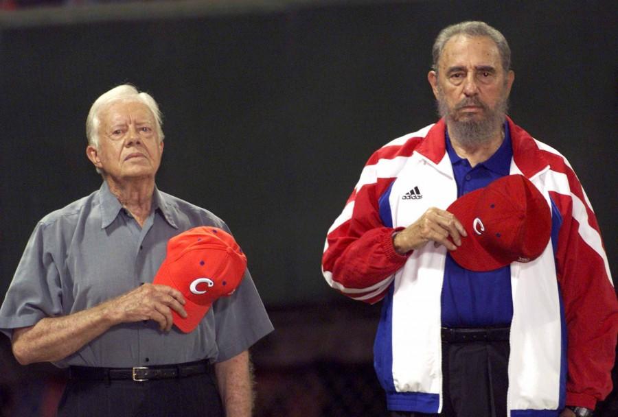 Former U.S. President Jimmy Carter and Cuba's President Fidel Castro (R) listen to the Cuban national anthem at the baseball stadium "Latinoamericano" in Havana in this May 14, 2002 file photo. Ailing Cuban leader Fidel Castro said on February 19, 2008 that he will not return to lead the country, retiring as head of state 49 years after he seized power in an armed revolution. Fidel Castro,Fidel Castro dead,Fidel Castro cuba,Fidel Castro dies,Fidel Castro passes away,Fidel Castro Iconic photos,Fidel Castro Iconic pics,Fidel Castro Iconic images,Fidel Castro rare pics,Fidel Castro rare images,Fidel Castro rare photos,Fidel Castr