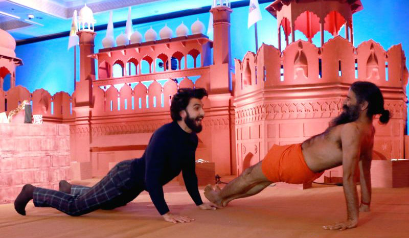Photos of Bollywood actor Ranveer Singh performs Yoga with Baba Ramdev in New Delhi. Ranveer Singh performs Yoga,Ranveer Singh performs Yoga with Baba Ramdev,Ranveer Singh,Ranveer Singh and Baba Ramdev,Ranveer Singh with Baba Ramdev