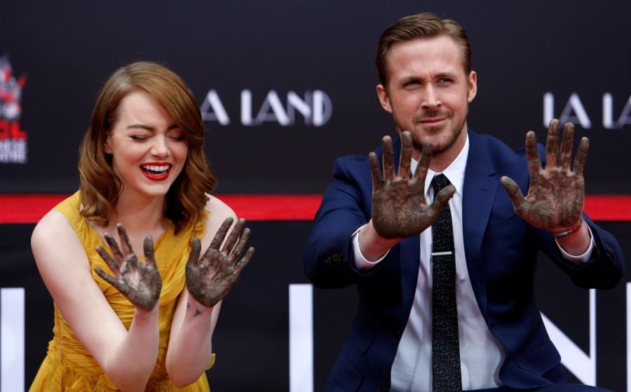 Photos of Emma Stone and Ryan Gosling place their hands in cement at the TCL Chinese theatre in Hollywood. Emma Stone and Ryan Gosling,Emma Stone,Ryan Gosling,Ryan Gosling and Emma Stone cemented,TCL Chinese theatre,Chinese theatre,Ryan Gosling and Emma Stone pics,Ryan Gosling and Emma Stone images,Ryan Gosling and Emma Stone photos,Ryan Gosling and Emma Stone
