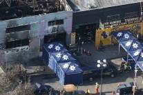 A coroner's truck is seen outside the burned warehouse following the fatal fire in the Fruitvale district of Oakland, California.