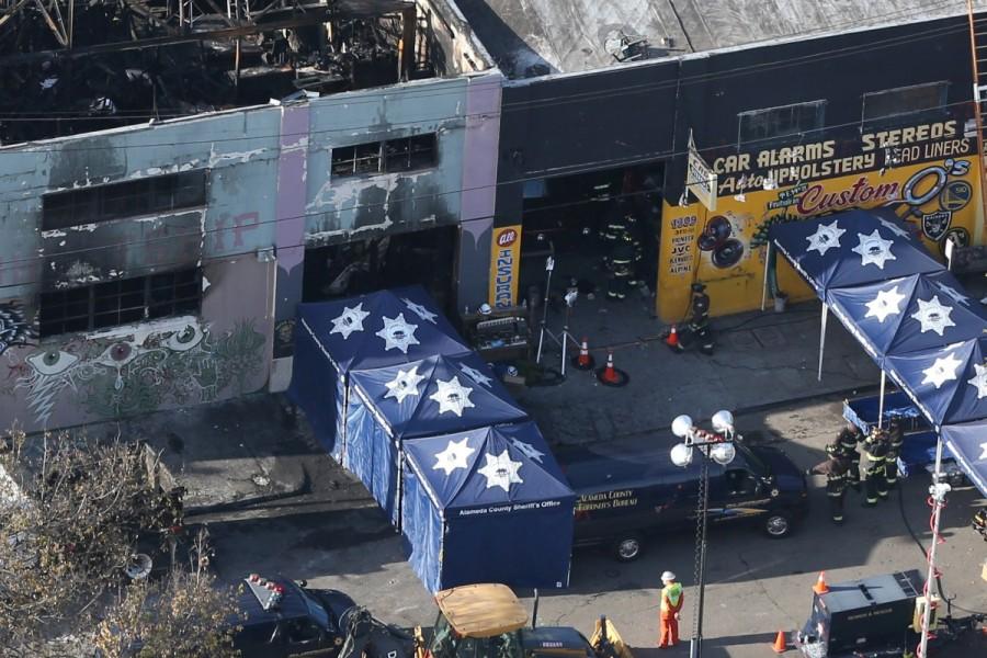 A coroner's truck is seen outside the burned warehouse following the fatal fire in the Fruitvale district of Oakland, California. Deadly California warehouse fire,California warehouse fire,California warehouse fire pics,California warehouse fire images,California warehouse fire photos,California warehouse fire stills,California warehouse fire pictures