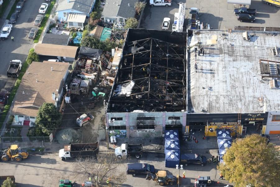 Firefighters work inside the burned warehouse following the fatal fire in the Fruitvale district of Oakland, California. Deadly California warehouse fire,California warehouse fire,California warehouse fire pics,California warehouse fire images,California warehouse fire photos,California warehouse fire stills,California warehouse fire pictures
