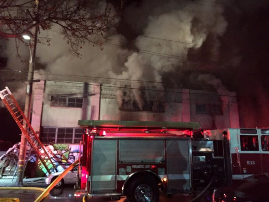 Smoke pours from a warehouse, which caught fire during a dance party in Oakland, California. Deadly California warehouse fire,California warehouse fire,California warehouse fire pics,California warehouse fire images,California warehouse fire photos,California warehouse fire stills,California warehouse fire pictures