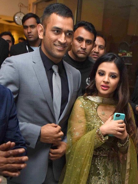 MS Dhoni and his wife Sakshi Rawat during wedding reception of cricketer Yuvraj Singh and actress Hazel Keech in New Delhi, on Dec 7, 2016. MS Dhoni,Harbhajan Singh,Sourav Ganguly,Yuvraj Singh and Hazel Keech's wedding reception,Yuvraj Singh wedding reception,Yuvraj Singh wedding reception pics,Yuvraj Singh wedding reception images,Yuvraj Singh wedding reception photos,Yuvraj Singh wed