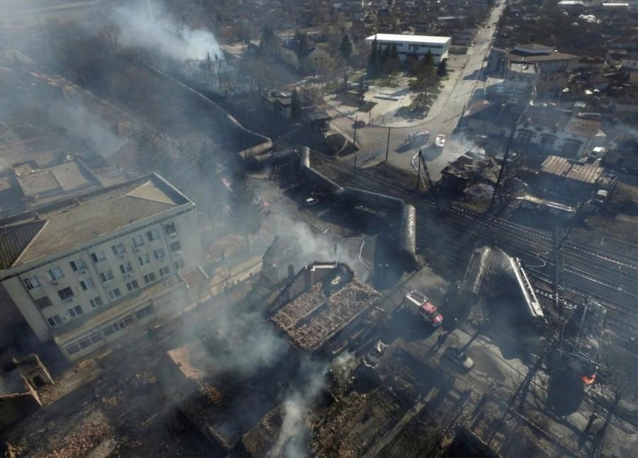 An aerial view shows the site where a cargo train derailed and exploded in the village of Hitrino, Bulgaria. Train derailment,Bulgaria train derailment,cargo train derails,Bulgaria,7 Killed,29 Injured in Bulgarian Tanker Train Explosion,Bulgarian Tanker Train Explosion,Tanker Train Explosion,freight train derailed