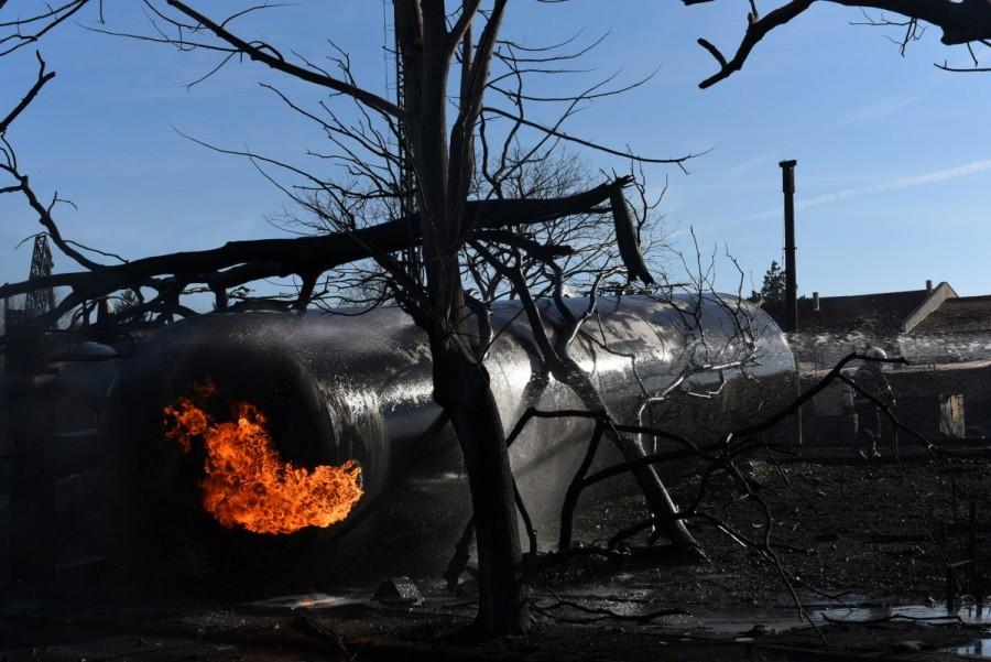 Firefighters work on the site where a cargo train derailed and exploded in the village of Hitrino, Bulgaria. Train derailment,Bulgaria train derailment,cargo train derails,Bulgaria,7 Killed,29 Injured in Bulgarian Tanker Train Explosion,Bulgarian Tanker Train Explosion,Tanker Train Explosion,freight train derailed