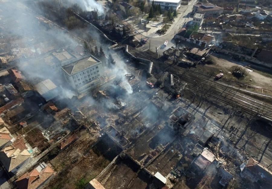An aerial view shows the site where a cargo train derailed and exploded in the village of Hitrino, Bulgaria. Train derailment,Bulgaria train derailment,cargo train derails,Bulgaria,7 Killed,29 Injured in Bulgarian Tanker Train Explosion,Bulgarian Tanker Train Explosion,Tanker Train Explosion,freight train derailed