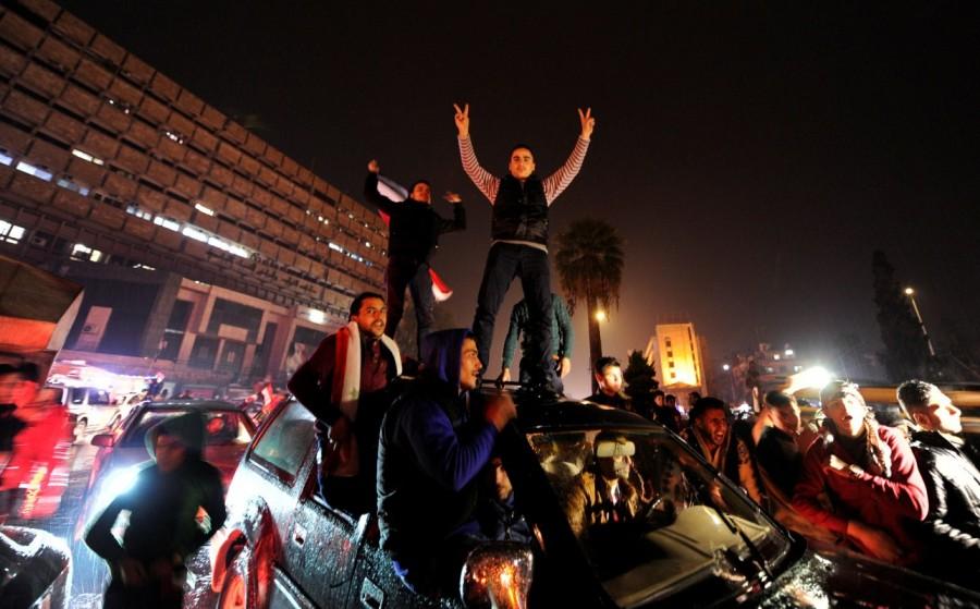 Supporters of Syria's President Bashar al-Assad carry their national flags and gesture as they tour the streets in celebration of what they say is the Syrian army's victory against the rebels in Aleppo, Syria December 12, 2016. Aleppo's rebels,Aleppo rebels,Rebels Holding Out in Aleppo Video,Aleppo Video,Beleaguered Rebels,President Bashar al-Assad,Bashar al-Assad