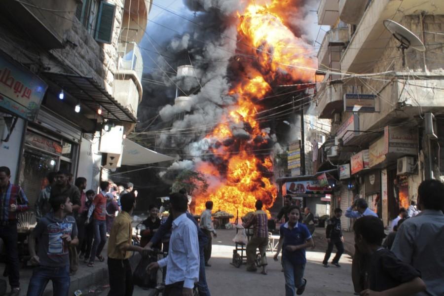 Residents run from a fire at a gasoline and oil shop in Aleppo's Bustan Al-Qasr neighbourhood October 20, 2013. Witnesses said the fire was caused by a bullet fired by a sniper loyal to Syrian President Bashar al-Assad at the Karaj al-Hajez crossing, a passageway separating Aleppo's Bustan al-Qasr, which is under the rebels' control and Al-Masharqa neighborhood, an area controlled by the regime. Aleppo,Pray for Aleppo,Aleppo rebel evacuation,Aleppo evacuation,Syrian city Aleppo,Aleppo: Since the beginning