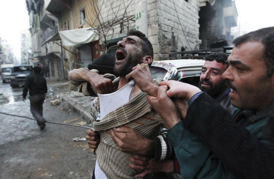 A father reacts after the death of two of his children, whom activists said were killed by shelling by forces loyal to Syria's President Bashar al-Assad, at al-Ansari area in Aleppo January 3, 2013. Aleppo,Pray for Aleppo,Aleppo rebel evacuation,Aleppo evacuation,Syrian city Aleppo,Aleppo: Since the beginning