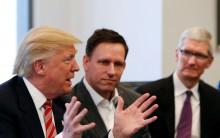 U.S. President-elect Donald Trump speaks as PayPal co-founder and Facebook board member Peter Thiel (C) and Apple Inc CEO Tim Cook look on during a meeting with technology leaders at Trump Tower in New York U.S., December 14, 2016.