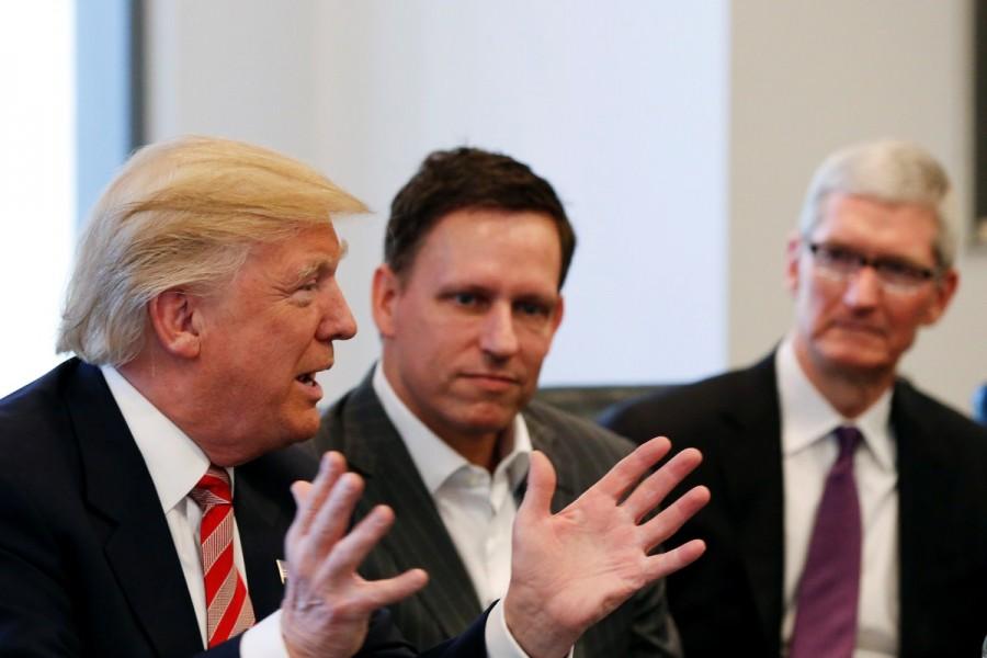 U.S. President-elect Donald Trump speaks as PayPal co-founder and Facebook board member Peter Thiel (C) and Apple Inc CEO Tim Cook look on during a meeting with technology leaders at Trump Tower in New York U.S., December 14, 2016. Donald Trump,Silicon Valley elite,Trump meets Silicon Valley elite,Donald Trump woos Silicon Valley tech elite,Trump meets Silicon Valley elite after mutual,Donald Trump And Silicon Valley Elite Seek