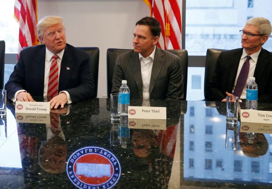 U.S. President-elect Donald Trump speaks while PayPal co-founder and Facebook board member Peter Thiel and Apple Inc CEO Tim Cook look on during a meeting with technology leaders at Trump Tower in New York U.S., December 14, 2016. Donald Trump,Silicon Valley elite,Trump meets Silicon Valley elite,Donald Trump woos Silicon Valley tech elite,Trump meets Silicon Valley elite after mutual,Donald Trump And Silicon Valley Elite Seek