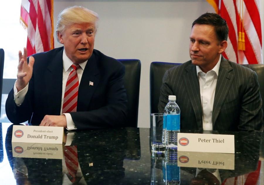 U.S. President-elect Donald Trump speaks while PayPal co-founder and Facebook board member Peter Thiel and Apple Inc CEO Tim Cook look on during a meeting with technology leaders at Trump Tower in New York U.S., December 14, 2016. Donald Trump,Silicon Valley elite,Trump meets Silicon Valley elite,Donald Trump woos Silicon Valley tech elite,Trump meets Silicon Valley elite after mutual,Donald Trump And Silicon Valley Elite Seek