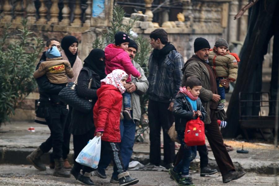 People carry their belongings as they flee deeper into the remaining rebel-held areas of Aleppo, Syria. Aleppo,Syrian city,Russia,rebel-held Aleppo,Syria,Syria crisis,Battles for Aleppo in Syria,Battles for Aleppo