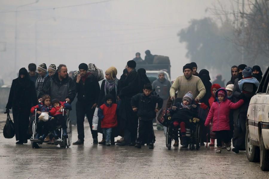 People walk as they flee deeper into the remaining rebel-held areas of Aleppo, Syria. Aleppo,Syrian city,Russia,rebel-held Aleppo,Syria,Syria crisis,Battles for Aleppo in Syria,Battles for Aleppo