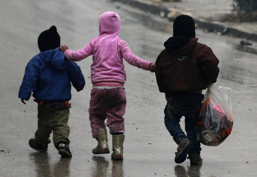 Children walk together as they flee deeper into the remaining rebel-held areas of Aleppo, Syria. Aleppo,Syrian city,Russia,rebel-held Aleppo,Syria,Syria crisis,Battles for Aleppo in Syria,Battles for Aleppo