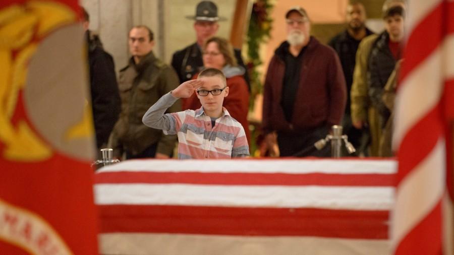 A young man pays his respects to former astronaut and U.S. Senator John Glenn as he lies in repose, under a United States Marine honor guard, in the Rotunda of the Ohio Statehouse in Columbus, Ohio, U.S., December 16, 2016. John Glenn,last respect John Glenn,John Glenn in Ohio,U.S. Sen. John Glenn,astronaut John Glenn,Ohio Statehouse