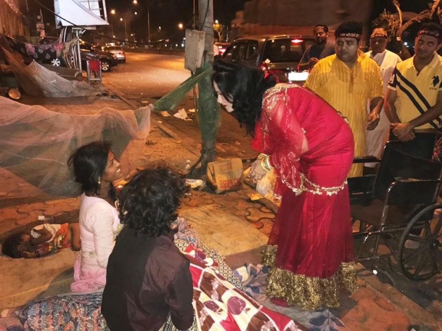 Radhe Maa even went a step ahead in secrecy. She walked up to a few people sleeping on the pavements, quietly wrapped a blanket around them and moved away. If it wasn't for her tika, bangles and disciples around her, Radhe Maa dressed in her patent bright scarlet-red attire, could almost be mistaken for Santa Claus. Radhe Maa,Salman Khan,godwoman Radhe Maa,Radhe Maa helps poor people,Radhe Maa pics,Radhe Maa images,Radhe Maa photos,Radhe Maa stills,Radhe Maa pictures