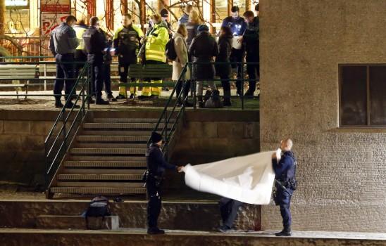 Police cover a body after a shooting outside an Islamic center in central Zurich, Switzerland December 19, 2016.