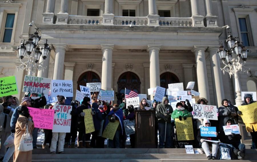 Protesters rally in front of the State Capitol as Michigan Electors gather inside to cast their formal votes in Lansing, Michigan. Donald Trump,Electoral College vote,Donald Trump wins Electoral College vote,president,270 electoral votes,White House