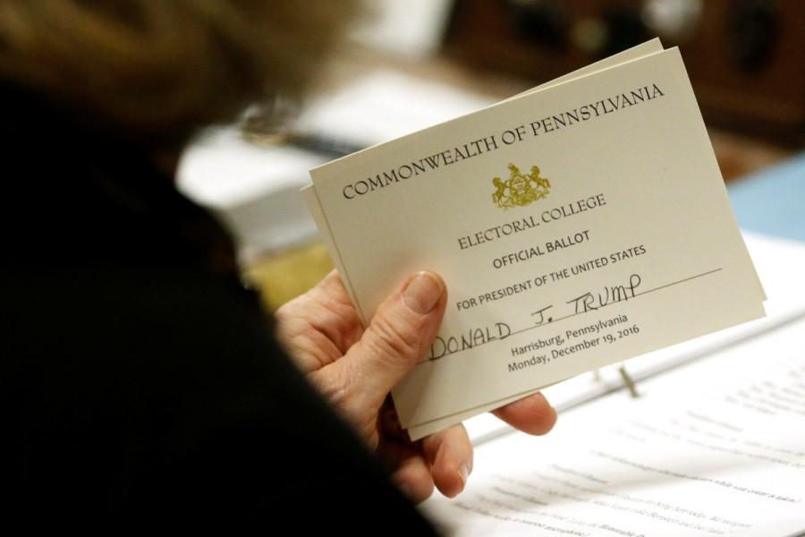 Pennsylvania elector Carolyn Bunny Welsh holds her ballot for President-elect Donald Trump before casting it at the Pennsylvania State Capitol in Harrisburg, Pennsylvania. Donald Trump,Electoral College vote,Donald Trump wins Electoral College vote,president,270 electoral votes,White House