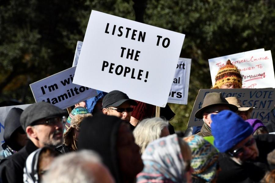 Activists demonstrate against President-elect Donald Trump ahead of the meeting of the Electoral College at the Texas State Capitol in Austin, Texas. Donald Trump,Electoral College vote,Donald Trump wins Electoral College vote,president,270 electoral votes,White House