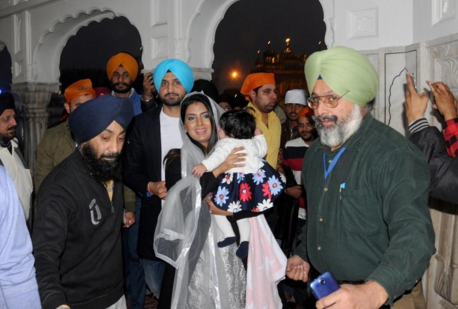 Indian cricketer Harbhajan Singh with his wife Geeta Basra and daughter Hinaya Heer Plaha pay obeisance at the Golden Temple in Amritsar on Dec 22, 2016. Harbhajan Singh,Geeta Basra,Harbhajan Singh and Geeta Basra,Hinaya Heer Plaha,Harbhajan Singh daughter Hinaya,Harbhajan Singh daughter Hinaya Heer Plaha,Golden Temple,Geeta Basra daughter,Geeta Basra daughter Hinaya Heer Plaha