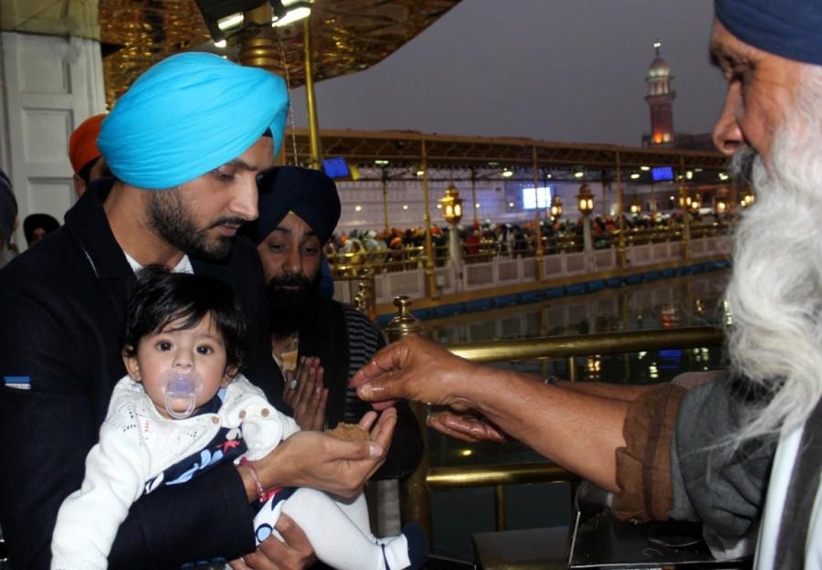 Indian cricketer Harbhajan Singh with his wife Geeta Basra and daughter Hinaya Heer Plaha pay obeisance at the Golden Temple in Amritsar on Dec 22, 2016. Harbhajan Singh,Geeta Basra,Harbhajan Singh and Geeta Basra,Hinaya Heer Plaha,Harbhajan Singh daughter Hinaya,Harbhajan Singh daughter Hinaya Heer Plaha,Golden Temple,Geeta Basra daughter,Geeta Basra daughter Hinaya Heer Plaha