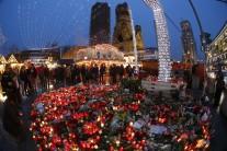 Flowers and candles are placed near the Christmas market at Breitscheid square.