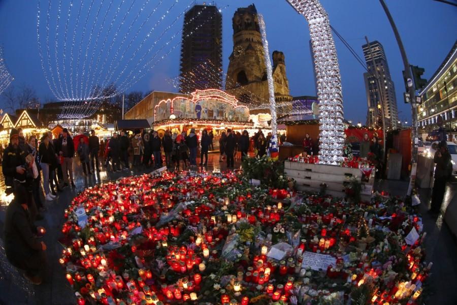 Flowers and candles are placed near the Christmas market at Breitscheid square. Berlin opens Christmas market,Berlin market,Christmas market,Christmas,Christmas 2016,Berlin Attack,Berlin Christmas market attack,berlin truck attack,Berlin Christmas market
