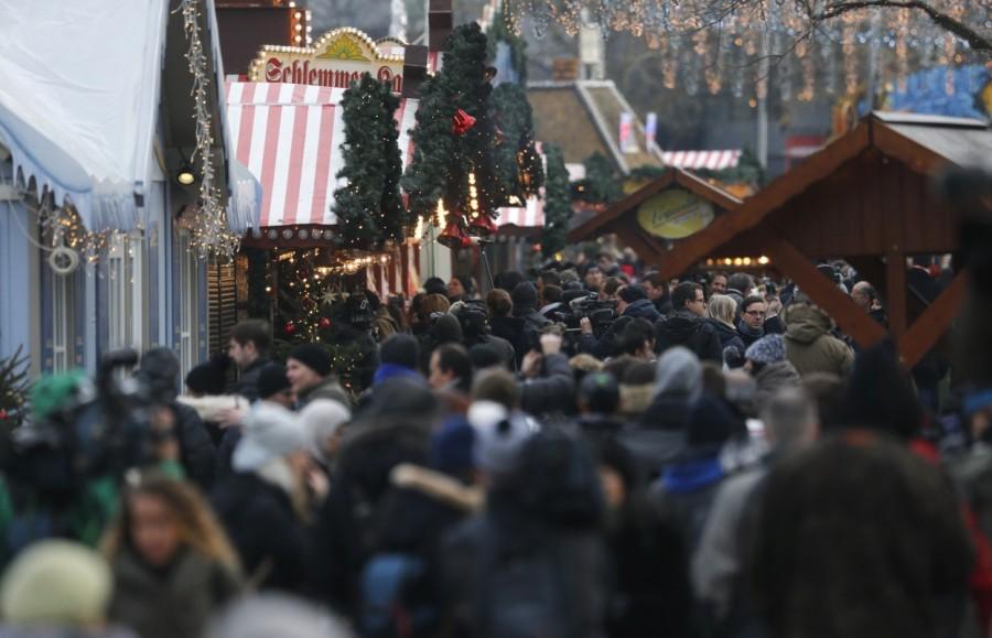 People walk through the re-opened Christmas market at Breitscheid square. Berlin opens Christmas market,Berlin market,Christmas market,Christmas,Christmas 2016,Berlin Attack,Berlin Christmas market attack,berlin truck attack,Berlin Christmas market
