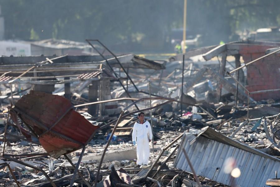 An investigator stands amidst the wreckage of houses destroyed in an explosion at the San Pablito fireworks market outside the Mexican capital, in Tultepec, Mexico December 21, 2016. Mexico fireworks market,mexico fireworks market blast,Deadly blast at Mexico,Mexico blast,fireworks market,San Pablito fireworks market,San Pablito fireworks,Mexican capital,Tultepec