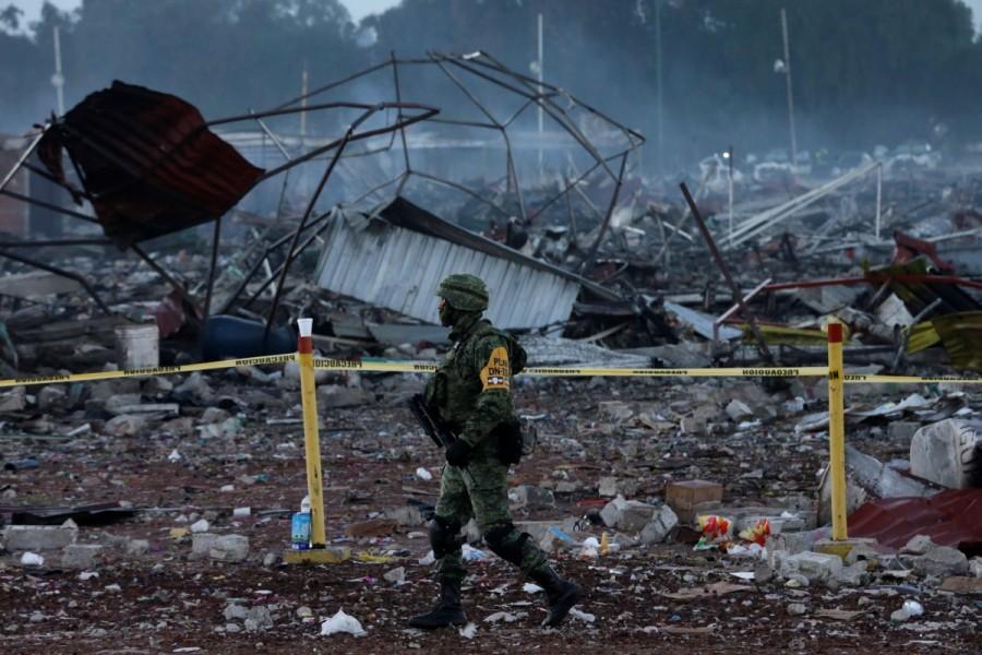 A soldier walks past a cordoned off area near the wreckage of houses destroyed in an explosion at the San Pablito fireworks market,outside the Mexican capital, in Tultepec, Mexico December 21, 2016. Mexico fireworks market,mexico fireworks market blast,Deadly blast at Mexico,Mexico blast,fireworks market,San Pablito fireworks market,San Pablito fireworks,Mexican capital,Tultepec