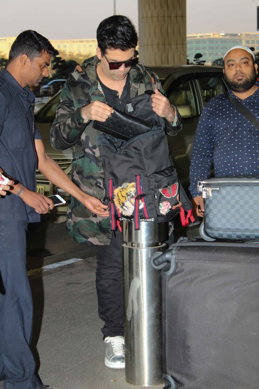Director Karan Johar spotted at airport. Karan Johar,Raveena Tandon,Shriya Saran,Karan Johar spotted at airport,Raveena Tandon spotted at airport,Shriya Saran spotted at airport,Celebs spotted at airport,Celebs at airport