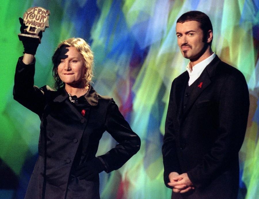 French designer Agnes B (L) holds high the special MTV "Free Your Mind" award given to the environmental group GREENPEACE during the MTV Europe Music Awards ceremony at the Zenith concert hall as George Michael (R) looks on , November 23, 1995. George Michael,george michael dead,George Michael death,George Michael photos,life in photos,George Michael with princess Diana,George Michael Paul McCartney,George Michael dies at 53,British singer George Michael