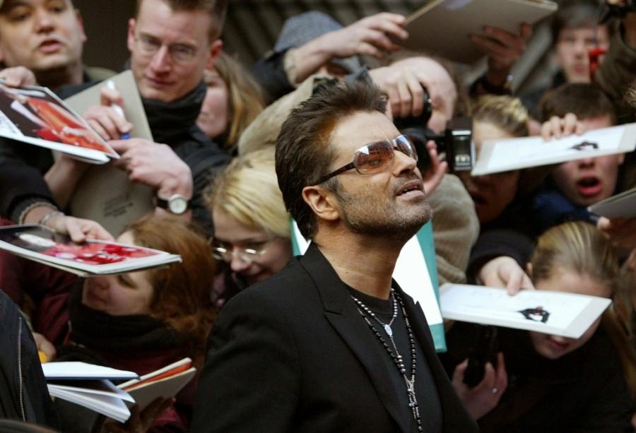 British singer and actor George Michael leaves a news conference for the film 'George Michael - A Different Story' in Berlin February 16, 2005. George Michael,george michael dead,George Michael death,George Michael photos,life in photos,George Michael with princess Diana,George Michael Paul McCartney,George Michael dies at 53,British singer George Michael