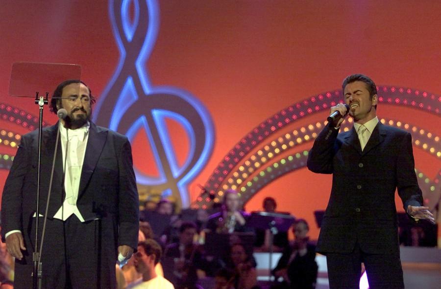 Italian tenor Luciano Pavarotti (L) performs with British pop singer George Michael during a "Pavarotti & Friends " concert in Modena June 6. George Michael,george michael dead,George Michael death,George Michael photos,life in photos,George Michael with princess Diana,George Michael Paul McCartney,George Michael dies at 53,British singer George Michael