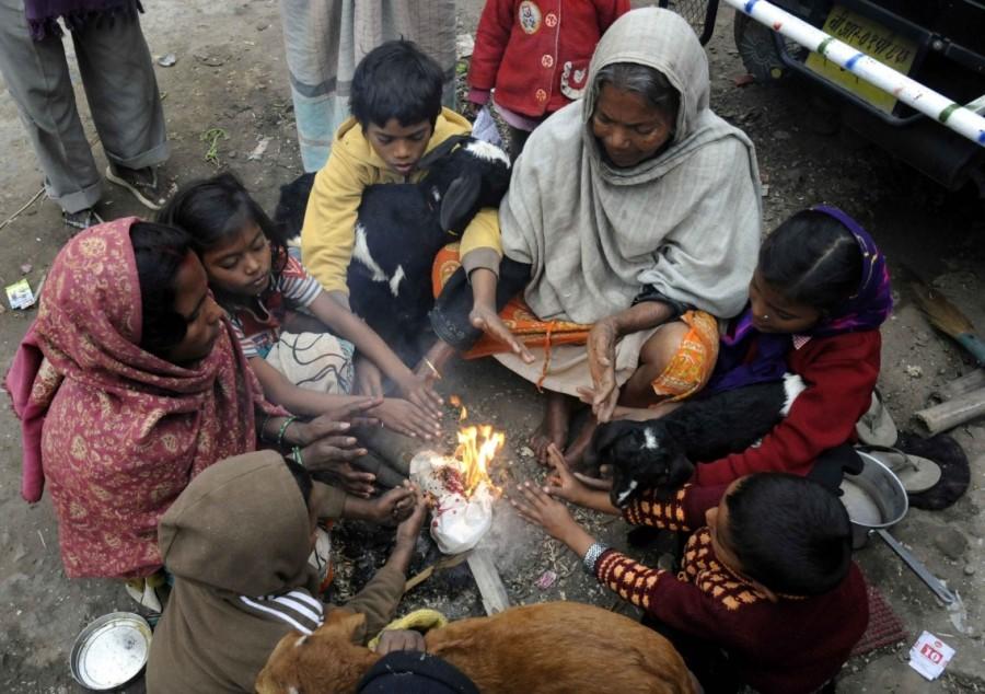 People warm themselves around a bonfire during a cold winter day in Patna on Dec 27, 2016. Patna shivers,temperature dips in Patna,cold winter in Patna,Patna shivers as temperature dips,minimum temperatures dipping