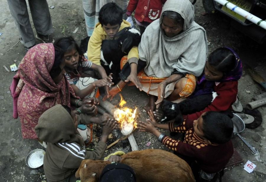 People warm themselves around a bonfire during a cold winter day in Patna on Dec 27, 2016. Patna shivers,temperature dips in Patna,cold winter in Patna,Patna shivers as temperature dips,minimum temperatures dipping