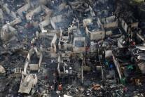 Residents sift through the ruins of their houses after a fire razed a squatter colony, in Quezon city, Metro Manila in the Philippines December 28, 2016. The fire left over a thousand families homeless.